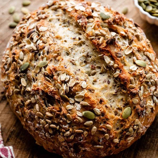 Round loaf of seeded oat bread with seeds on top