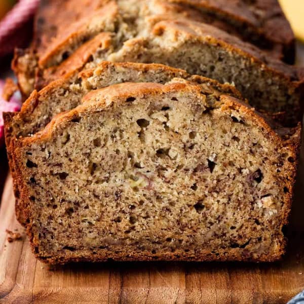 Sliced banana bread on a wood cutting board