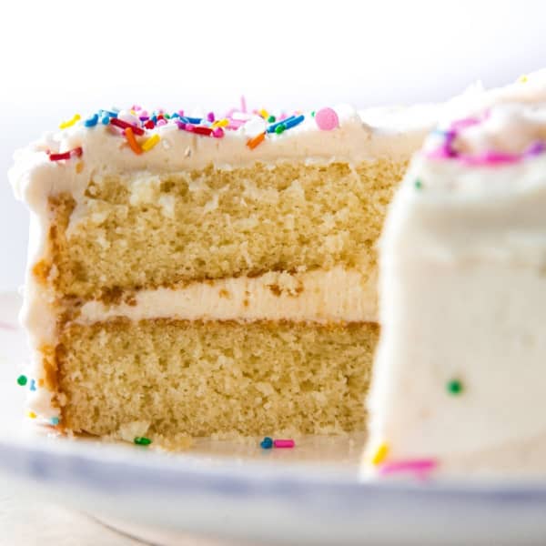 picture of a two layer white cake with slice removed