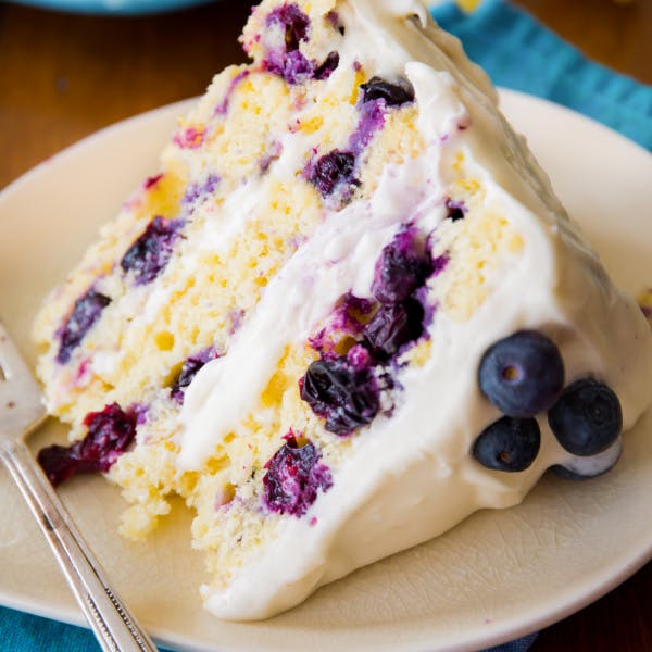 slice of three layer lemon blueberry cake