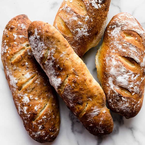 four loaves of golden brown artisan bread