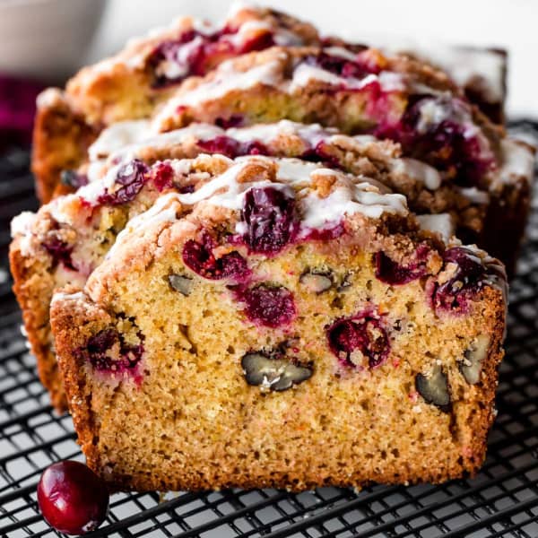 slices of orange cranberry quick bread with an icing glaze