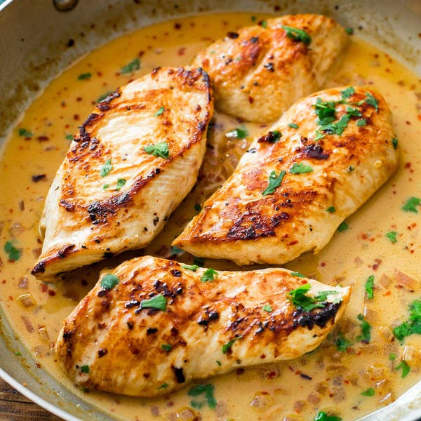 chicken with creamy sauce in a skillet