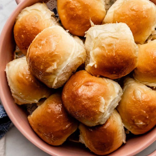 Honey butter rolls in a pink bowl