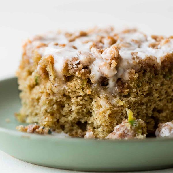 square slice of zucchini crumb cake with icing