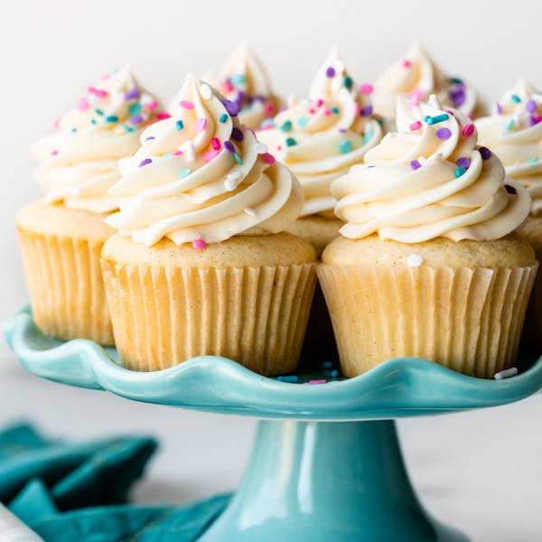 vanilla cupcakes on blue cake stand