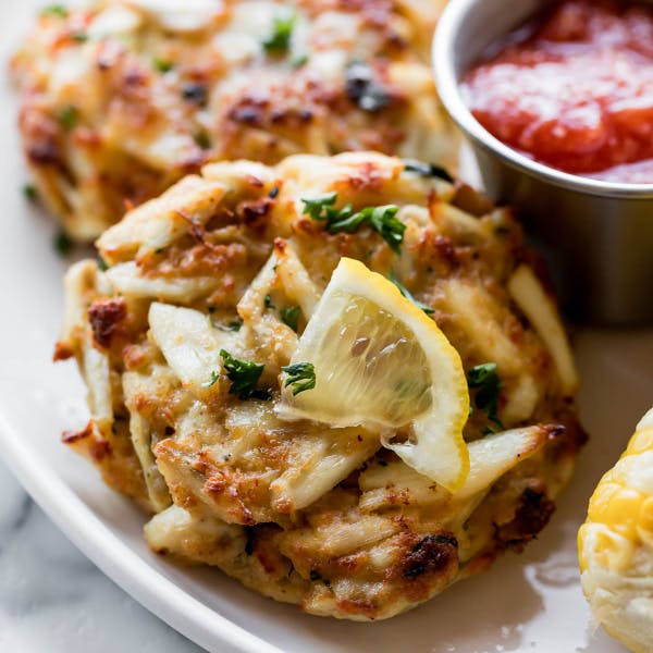 picture of crab cakes on a plate with lemon slices