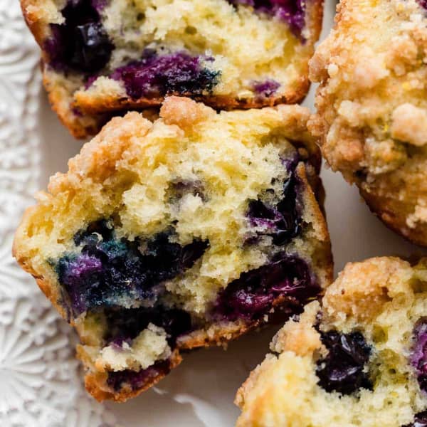 Lemon blueberry muffins on a plate, showing fluffy interior