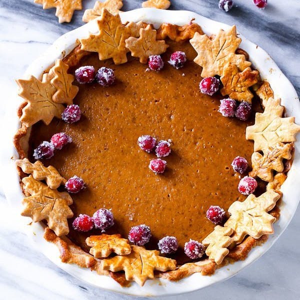 Picture of a pumpkin pie with pie crust leaves on top