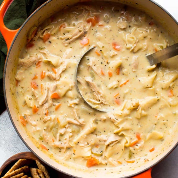 Dutch oven filled with creamy chicken noodle soup