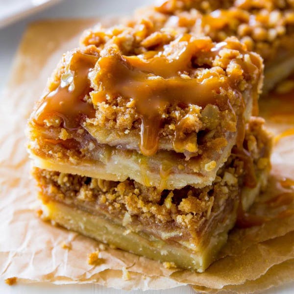 slices of apple pie bars with salted caramel drizzle