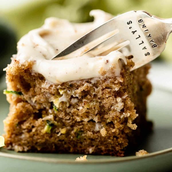 square slice of one layer zucchini cake with cream cheese frosting 