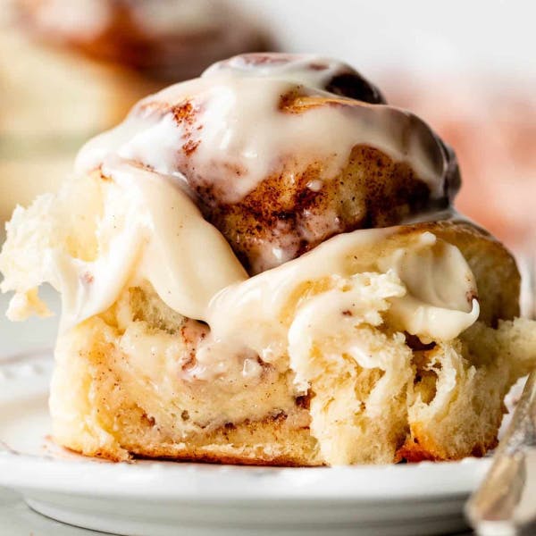 close up of a cinnamon roll with icing