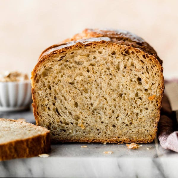 sliced loaf of honey oat bread