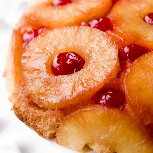 close up of pineapple upside down cake with cherries