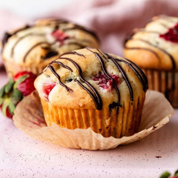 chocolate covered strawberry muffins with a chocolate drizzle on top