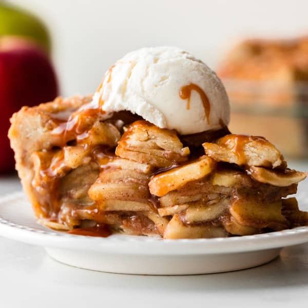 slice of caramel apple pie with a scoop of ice cream