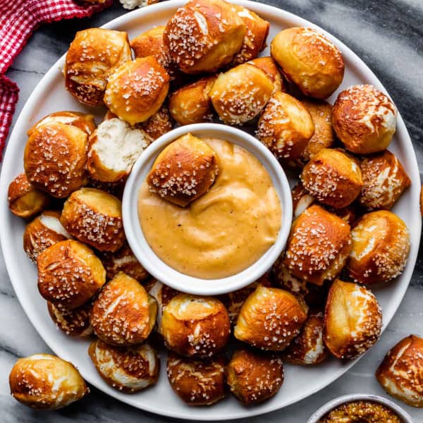 Golden brown soft pretzel bites with cheese dipping sauce