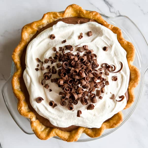 French Silk Pie with whipped cream and chocolate curls