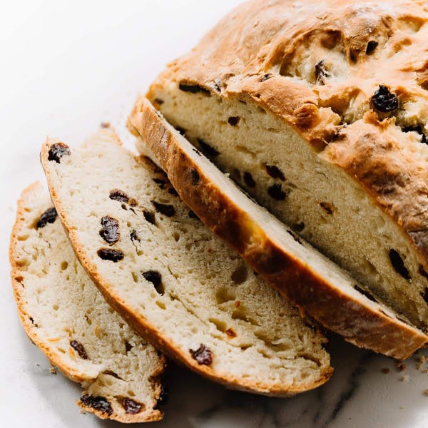 sliced round loaf of bread with raisins