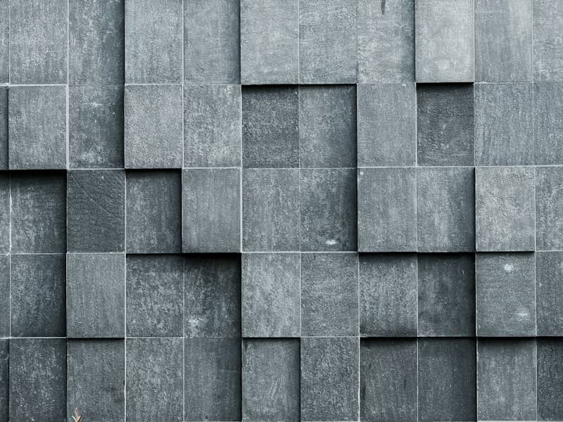 Textured gray stone wall with a geometric pattern