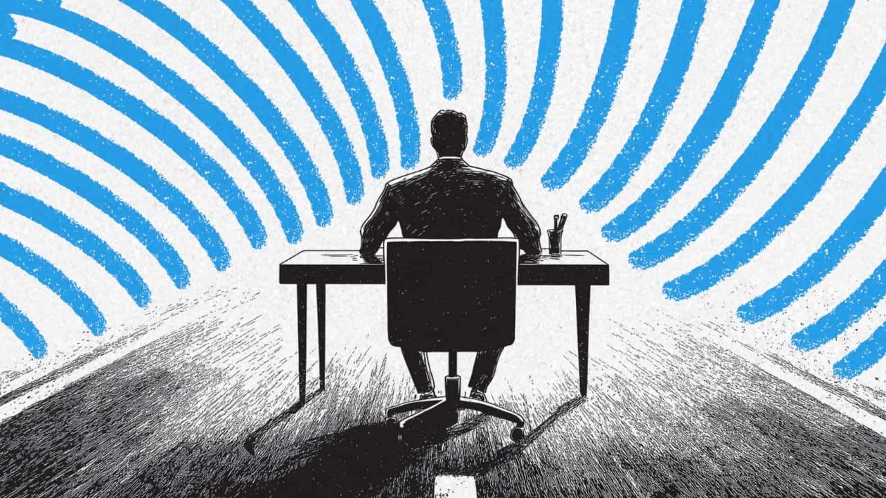 A person working on a desk, focused
