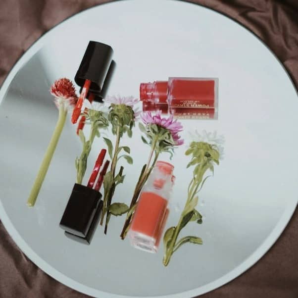 white and pink labeled soft tubes on white round plate