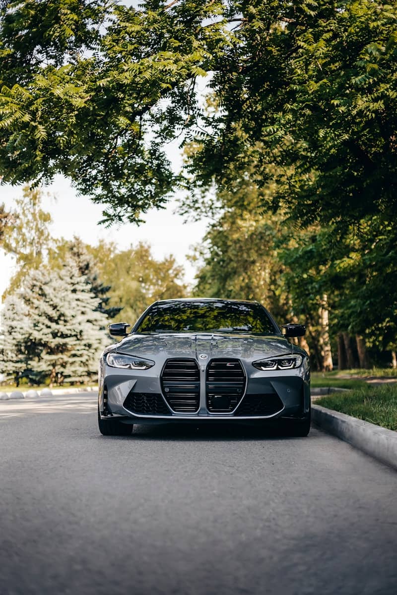 A silver sports car parked on the side of the road