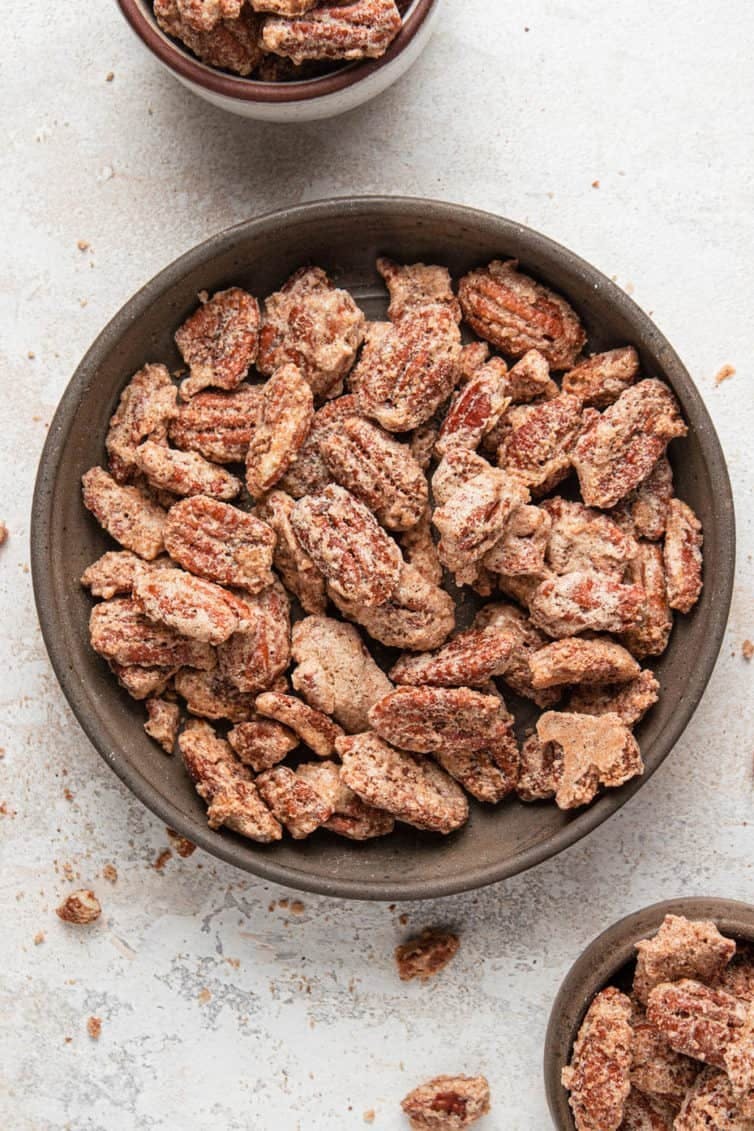 Overhead image of cinnamon sugar candied pecans in a bowl.