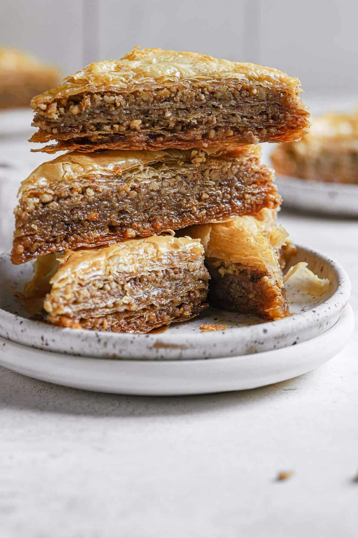 stack of 3 pieces of baklava on a white plate