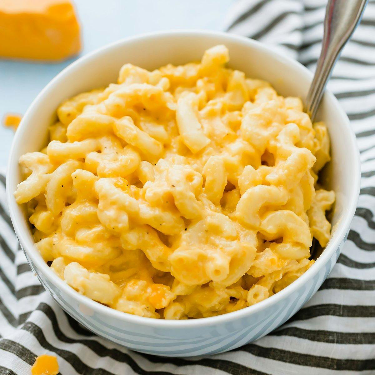 Serving of mac and cheese in a white bowl.