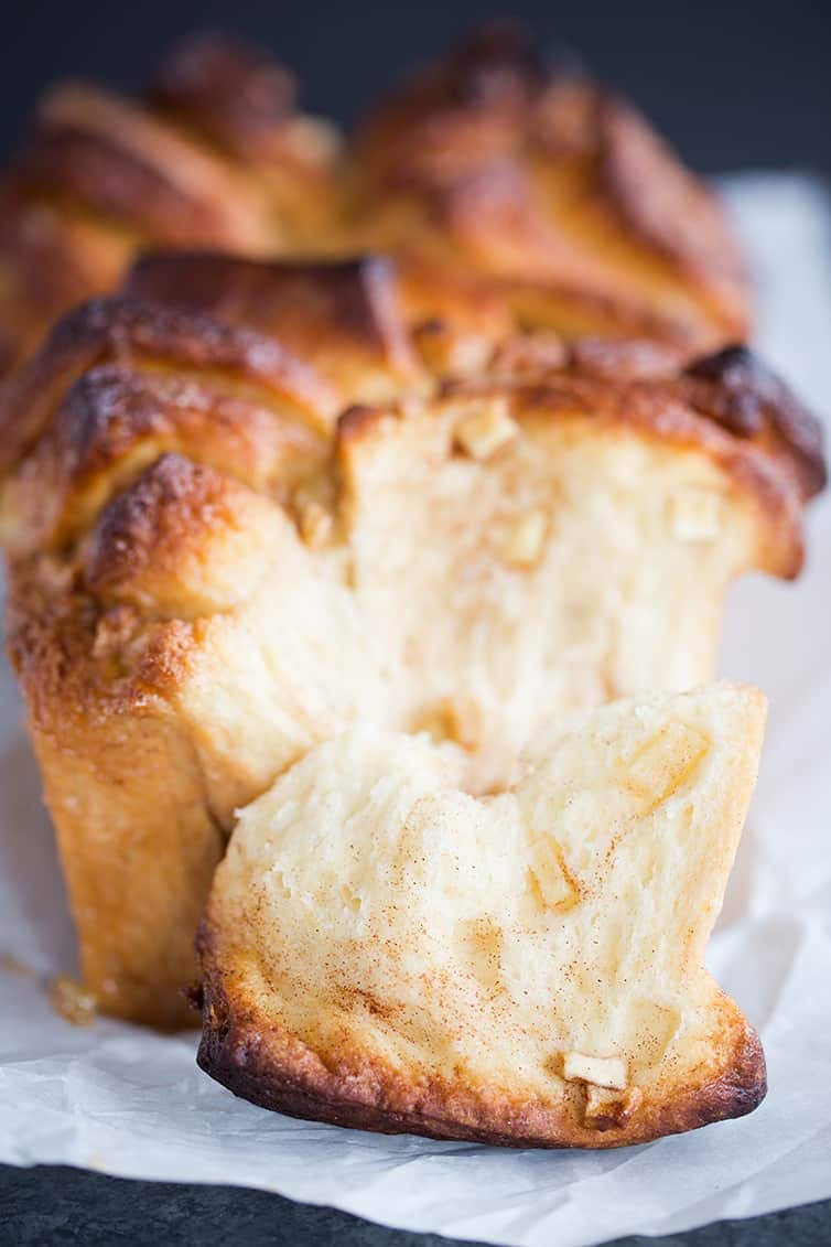 side view of apple cinnamon pull apart bread with a portion removed showing the texture