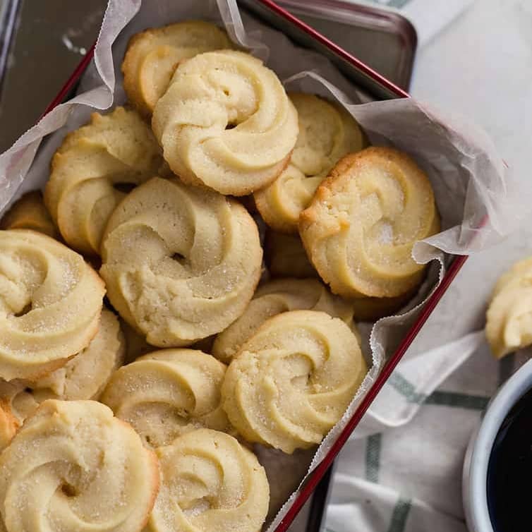 Overhead image of butter cookies in a tin.