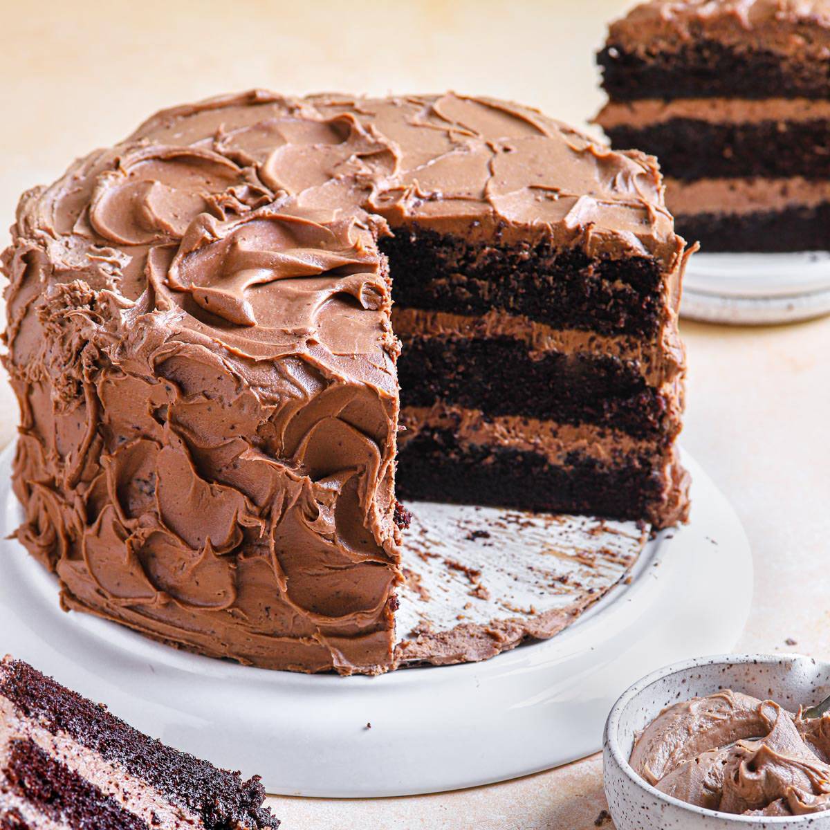 Square of chocolate sheet cake on a white plate with a fork.