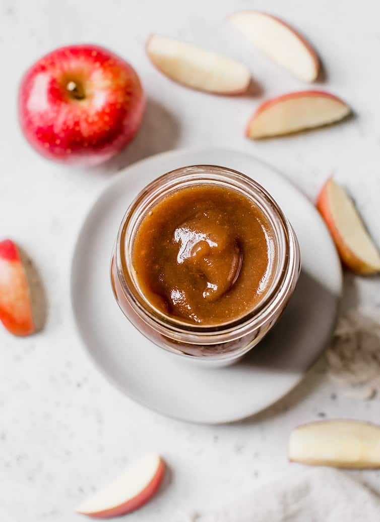 Overhead image of apple butter in a glass jar.