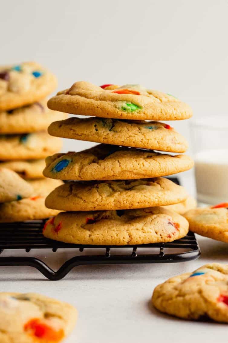 stack of 5 m&m cookies on a cooling rack