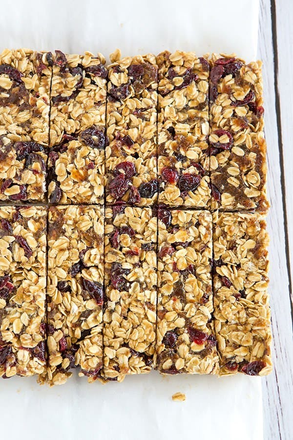 overhead image of granola bar mixture in a baking dish cut into bars