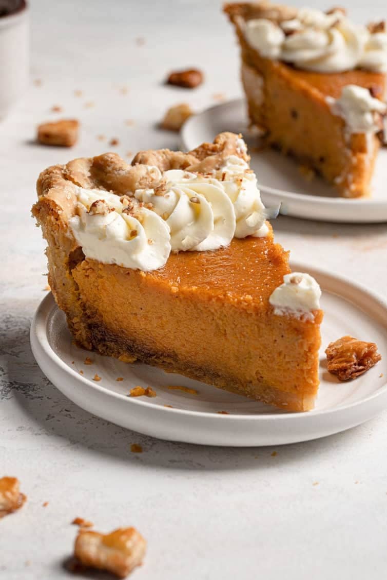 Slice of sweet potato pie on a white plate.