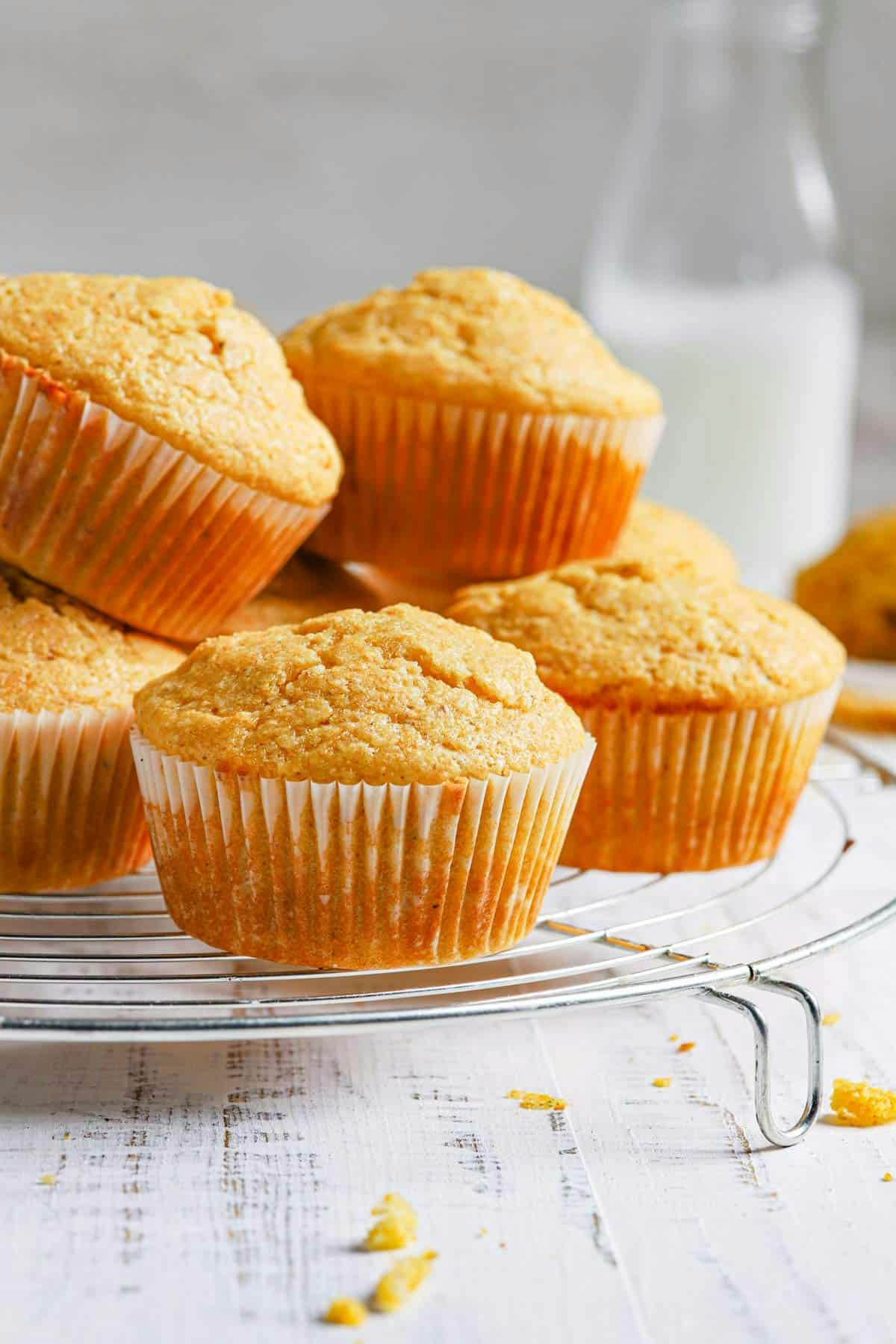 side view of a stack of cornbread muffins on a cooling rack