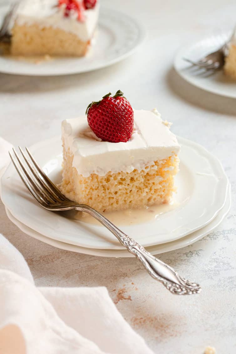 slice of tres leches cake on a white plate