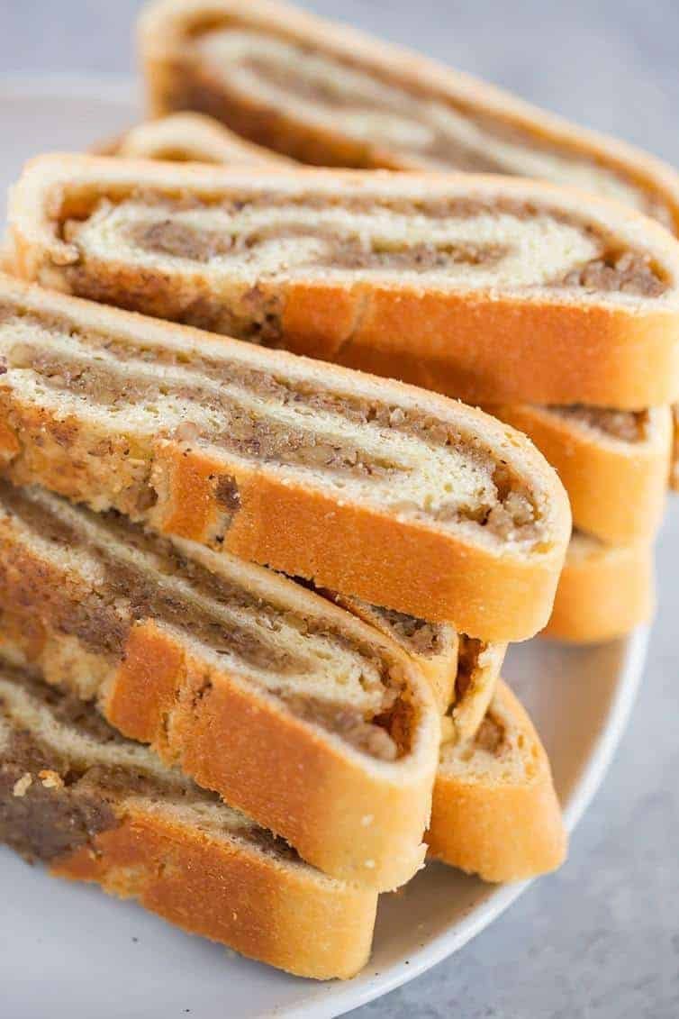 Slices of nut roll on a white serving plate.