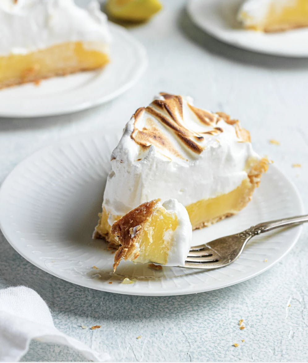 slice of lemon meringue pie on a white plate
