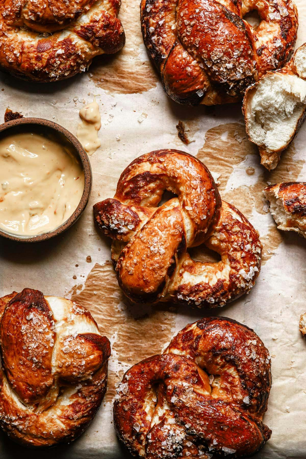 overhead image of soft pretzels on a parchment paper lined baking sheet