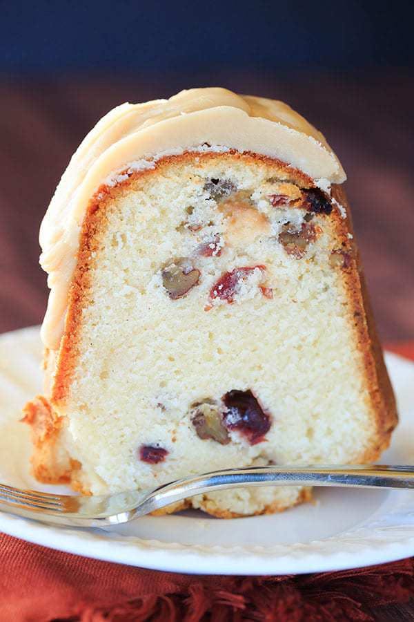 side view of a slice of cranberry pecan pound cake