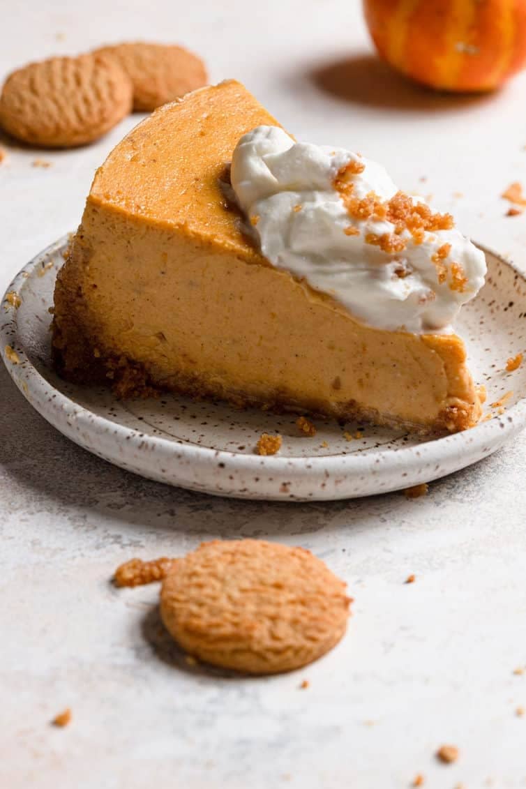 Slice of pumpkin cheesecake on a plate.