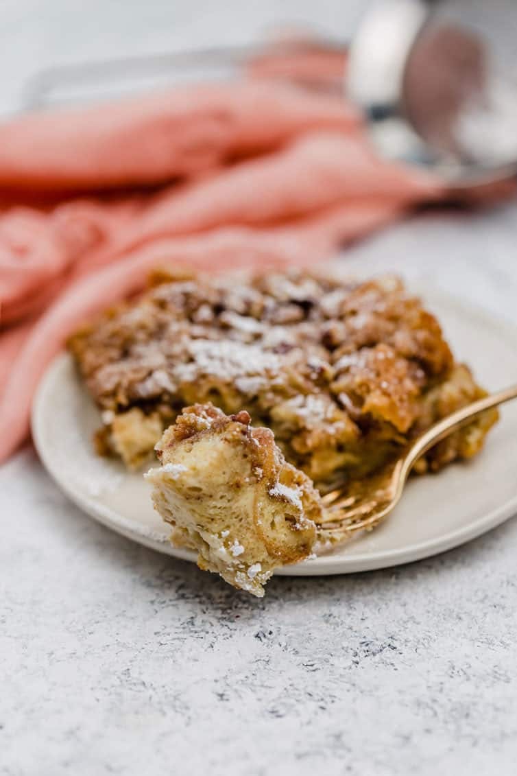 Serving of baked french toast casserole on a white plate.