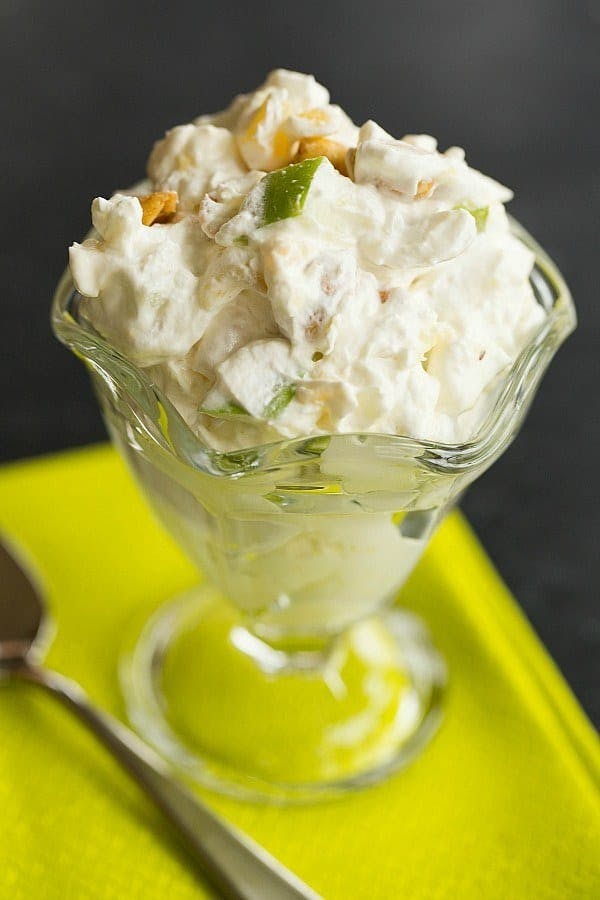 Serving of taffy apple salad in a dessert glass.