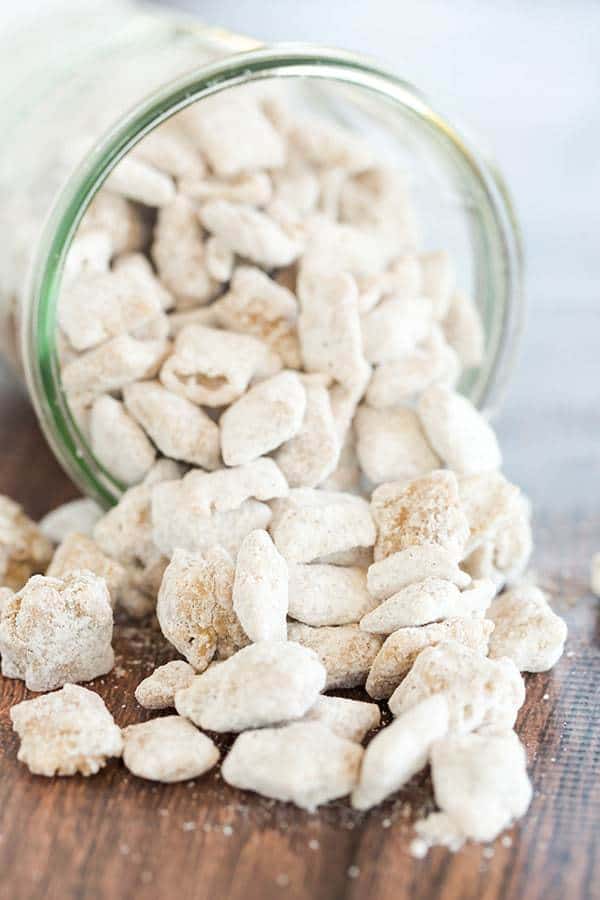 glass jar tipped on it's side with snickerdoodle muddy buddies in it