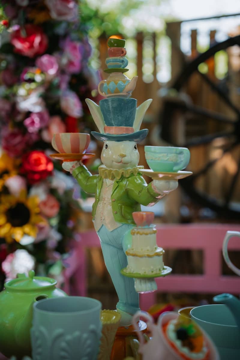 A rabbit statue is decorated with tea cups.