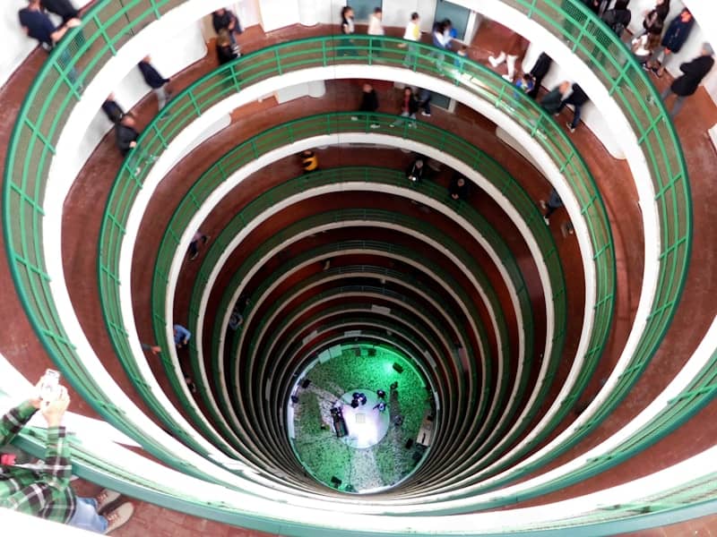 Looking down a circular, multi-level building interior